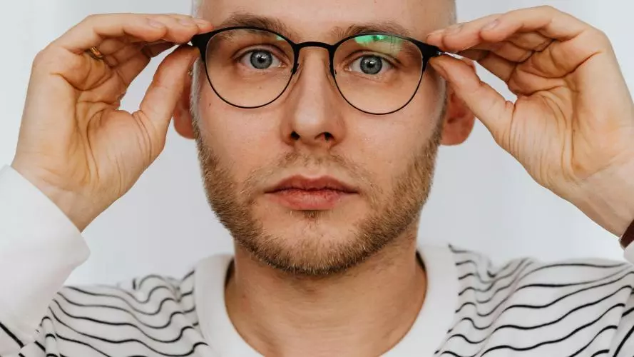 headshot of a man in stripey shirt