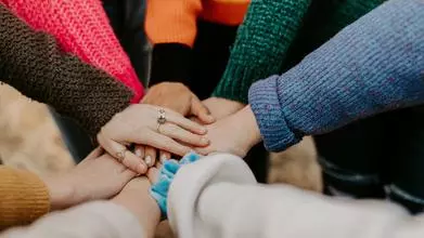 group of hands placed on top of each other