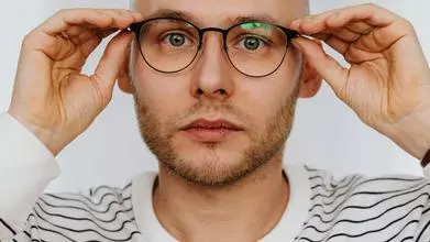 headshot of a man in stripey shirt