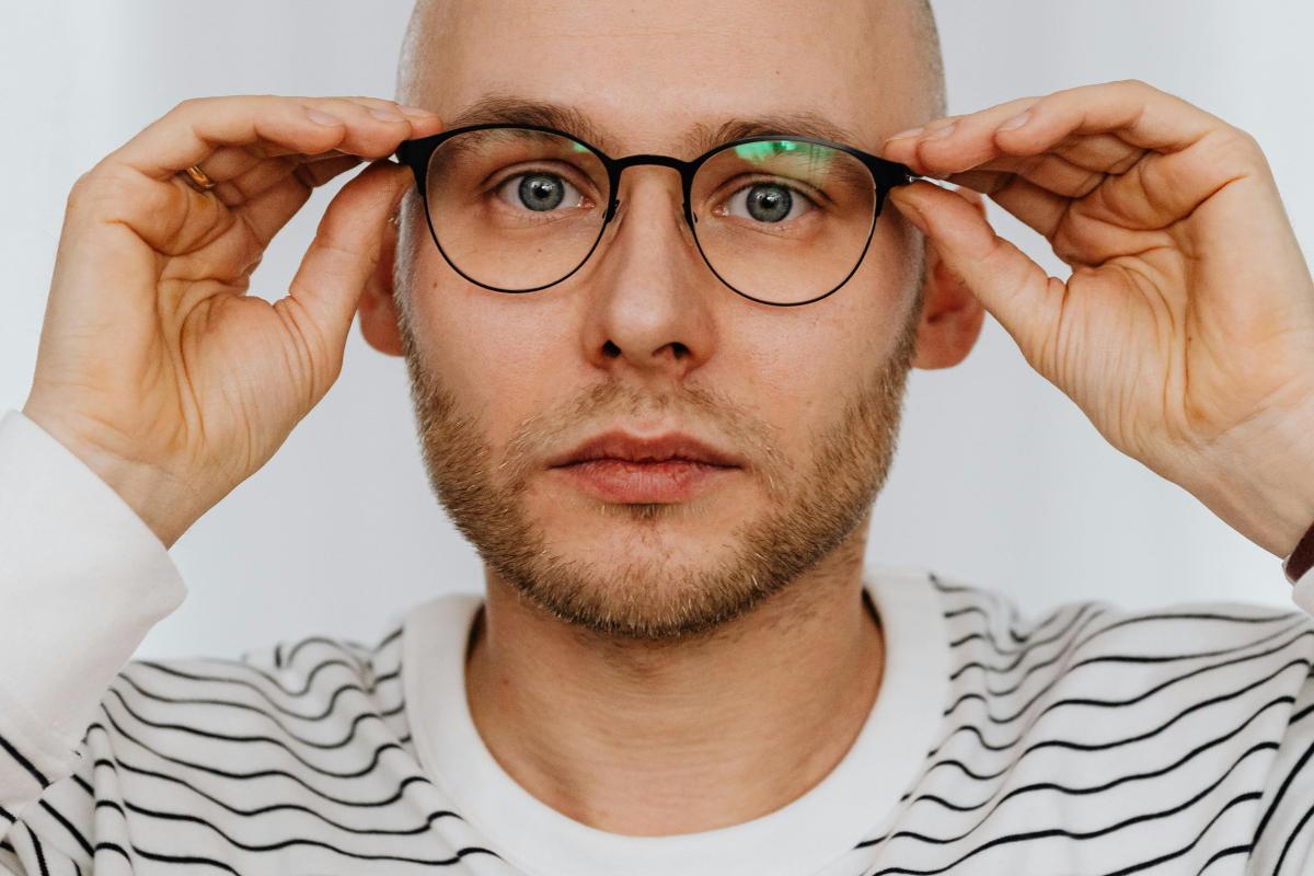 headshot of a man in stripey shirt